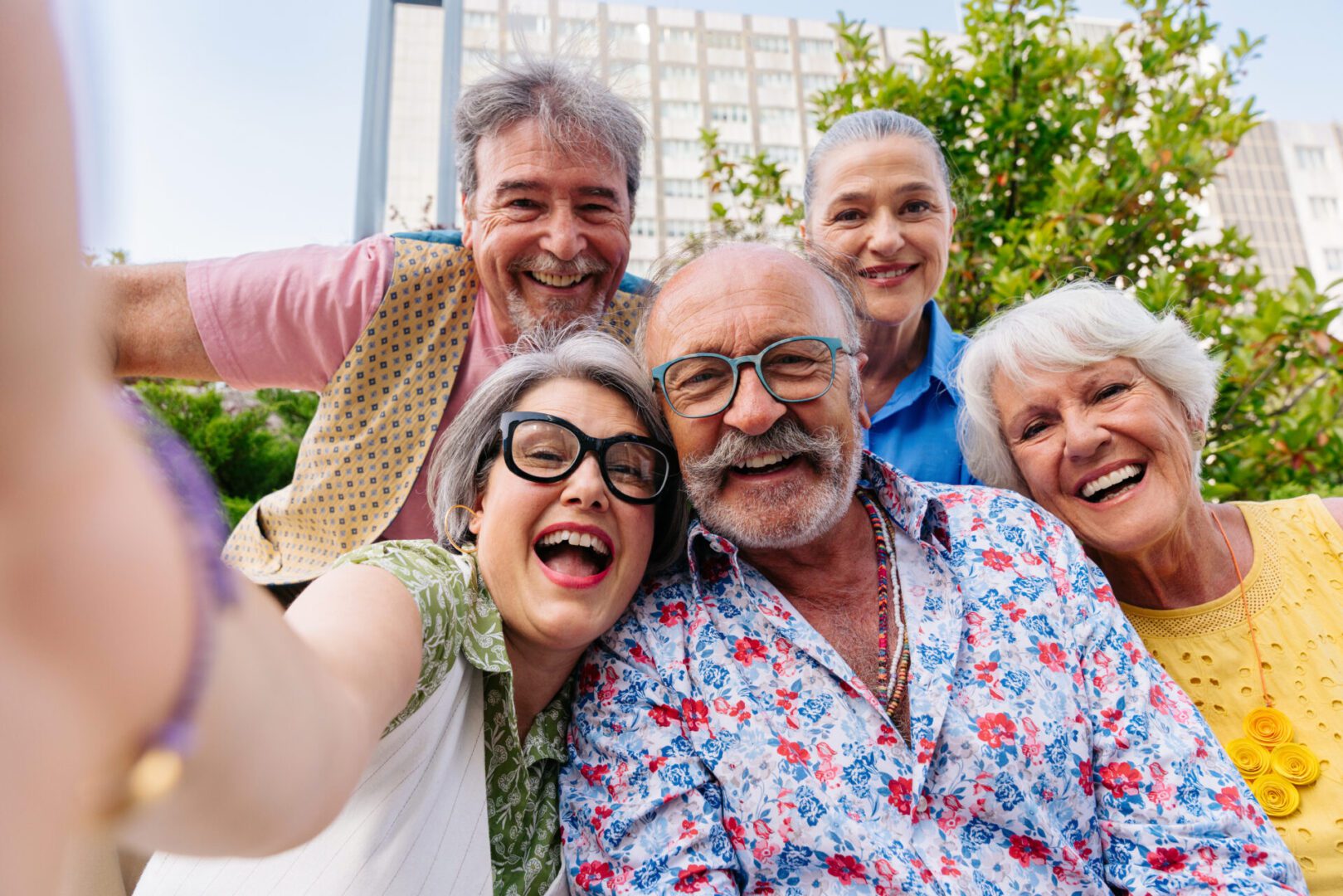 Group of senior friends meeting outdoors in the city and having fun - Cheerful old people bonding together, concepts about elderly, quality of life and aging lifestyle